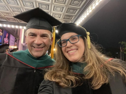 Convocation speaker Roberto Muñiz, president and CEO of Parker Health Group takes a photo during convocation with Sonia Garcia Laumbach, MD, assistant dean for student affairs